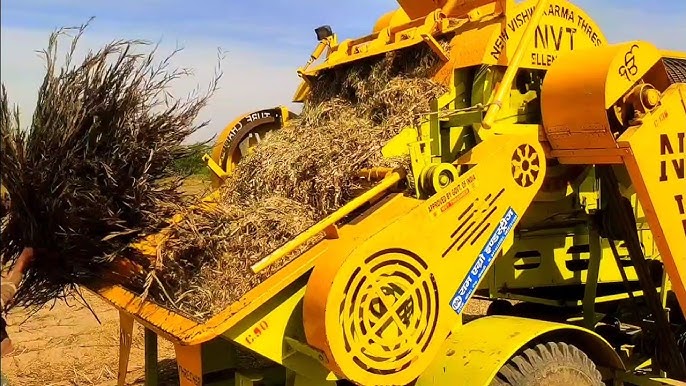 Close-up of a farmer operating a mini combine harvester